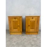 A pair of cotemporary maple bedside cabinets fitted with slides above panel doors. H.60 W.41 D.41cm.