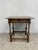 An early 20th century Jacobean style Ipswich Oak side table with frieze drawer on turned stretchered