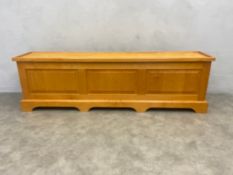 A contemporary maple hall bench or coffer of panelled construction with hinged lid. H.50 W.172 D.