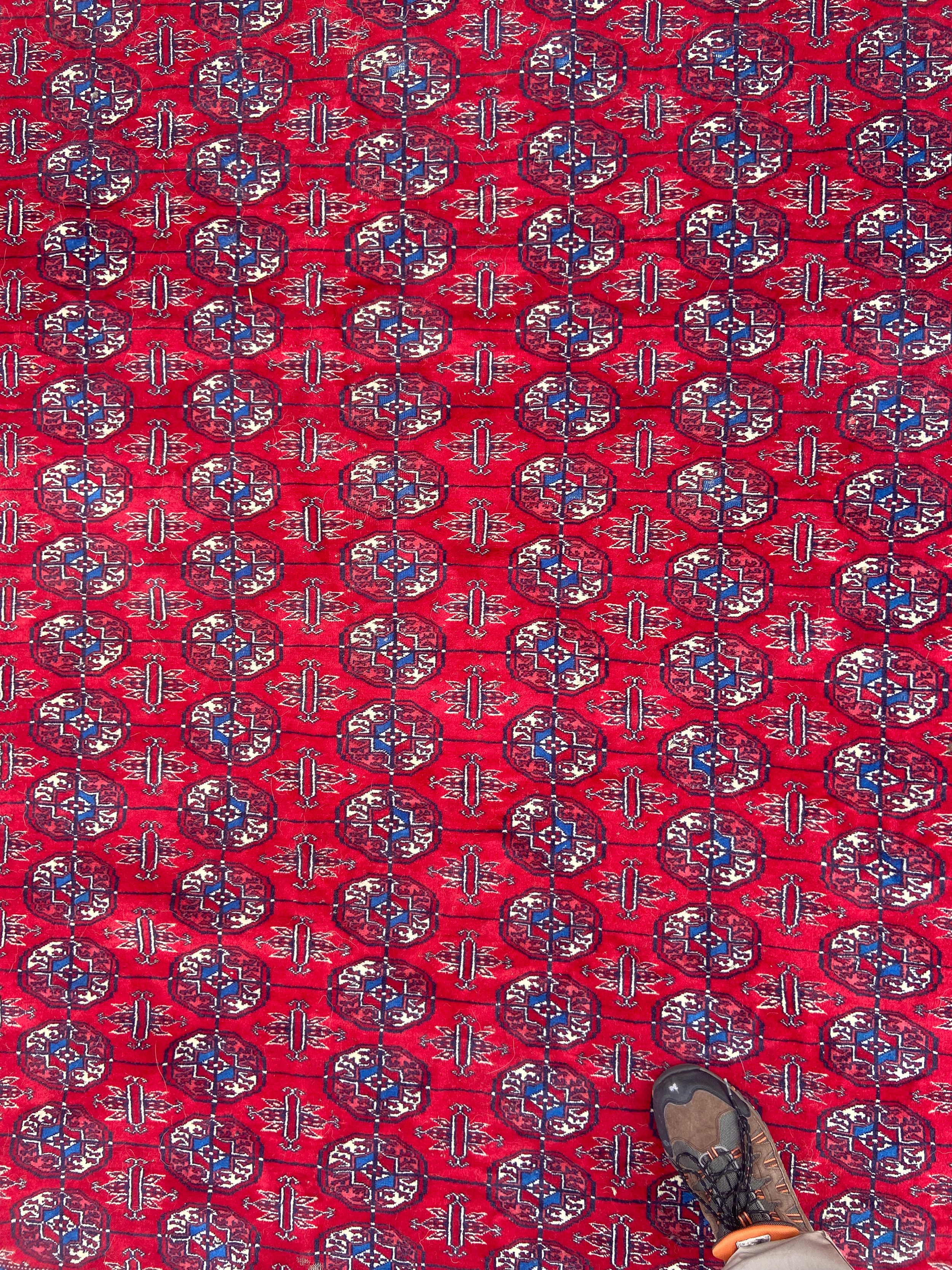 A large bokhara carpet with repeating gul motifs across a burgundy field within multiple stylised - Image 4 of 4