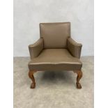 A large Georgian style library armchair in studded leather upholstery on shell carved ball and