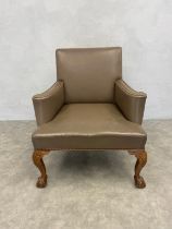 A large Georgian style library armchair in studded leather upholstery on shell carved ball and