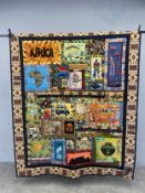 A hand woven South African bed cover or blanket, lightly quilted with multiple panels, depicting