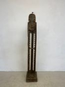 A vintage figural teak CD rack. H.156cm