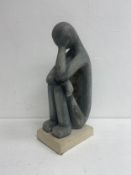 A carved stone seated figure in the modernist style signed and dated Makis to the base. H.