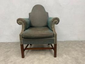 A Georgian mahogany framed library tub armchair on square stretchered supports. H.96cm.