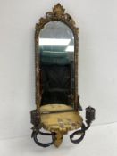 A small 19th century girandole wall mirror with twin sconces in a giltwood and gesso frame with