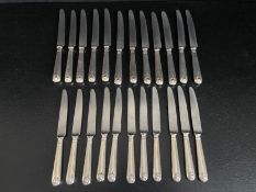 A set of twelve silver handled Thread and Shell pattern dinner knives and eleven matching dessert