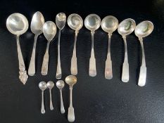 A set of five hallmarked silver sauce ladles along with various spoons and ladles bearing silver
