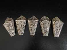 Three South East Asian silver betel leaf holders with all-over pierced repousse foliate decoration