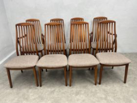 A set of eight mid-century teak dining chairs with high slatted backs above calico pad seats to