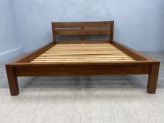 A contemporary hardwood bedstead to take a standard double 4'6