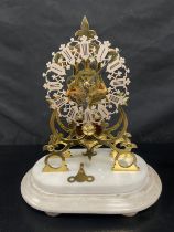 A late 19th century brass skeleton clock with chain driven fusee movement on stepped marble base.