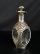 A Chinese export silver mounted dimple decanter with pierced stylised foliate decoration. H.25cm.