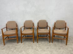 A set of four mid-century style teak framed salon armchairs in piped calico upholstery.