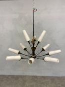 A mid-century starburst ceiling chandelier with opaque glass shades on metal, brass and glass frame.