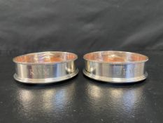 A pair of silver wine coasters, London hallmarks. Dia. 13cm.