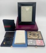 A collection of small leather goods to include an Asprey & Garrard photo frame, a Smythson 'ten
