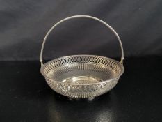 A silver basket with swing handle and pierced decoration marked Sterling Silver. 262g.
