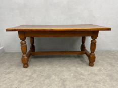 A mid 20th century Jacobean style oak refectory dining table with solid plank top on stretchered