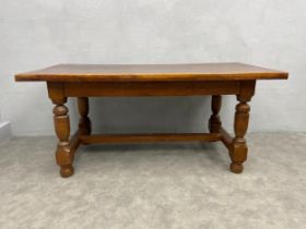 A mid 20th century Jacobean style oak refectory dining table with solid plank top on stretchered