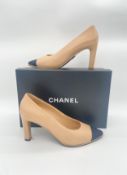 A pair of Chanel nude leather shoes with logo on black grosgrain size 40 (boxed). Light signs of