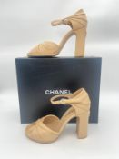 A pair of Chanel nude leather block healed sandals with ankle strap size 39.5, some signs of light