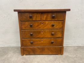 A 19th century flame mahogany miniature/jewellery chest of drawers with satinwood inlay. H.37 W.38