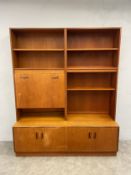 A mid-century teak G-Plan three section bookcase with adjustable shelves and cabinet section above