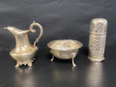 An Irish silver three footed bowl, Dublin 1877, an embossed silver sugar sifter, London 1888 and a