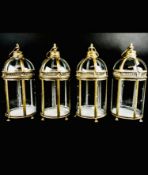 A set of four Regency style storm lanterns in domed gilt metal frames fitted with opening panel