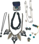 A mixed collection of costume jewellery to include a 22 carat gold plated Paua shell brooch, a