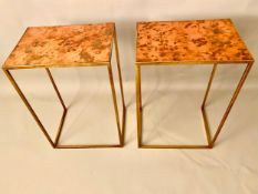 A pair of contemporary occasional or lamp tables with mottled copper tops and gilt metal frames.