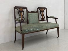 An Edwardian mahogany salon settee or sofa having a stepped top rail with a central upholstered back