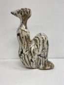 A modernist study of a seated woman in resin coated scagliola. H.43cm.