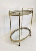 An Art Deco style drink's trolley in a silvered metal frame with pierced gallery and mirrored top