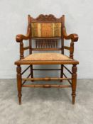 A late 19th century walnut armchair in the manner of Charles Eastlake reupholstered in tapestry