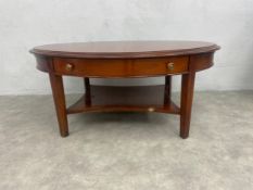 A contemporary cherrywood coffee table with two frieze drawers and two leather inset slides. H.51