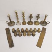 A mixed collection of brass to include three pairs of candlesticks, twelve door knobs and four
