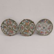 A set of three hand painted 19th century Chinese Famille Rose porcelain plates each with a central