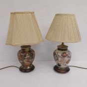 Two hand painted and gilt Japanese Kutani style ceramic table lamps with shades on wooden bases. H.