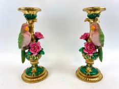A pair of moulded polychrome candlesticks with parrot and pink rose decoration. 31 x 13 x 13cm