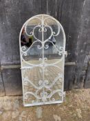 A wall mirror with painted scrolling iron-work frame. 145 x 64cm