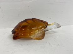 A Lalique amber and clear glass turtle etched Lalique France to the underside. W.15cm.