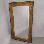 A C.1900 gilt wall mirror with rectangular plate in a scrolling foliate frame. 147 x 86cm