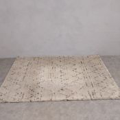 A contemporary 'Berber' rug by John Lewis with a distressed latticework field over a faux abrash