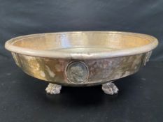 A large 20th century silver plated bowl having a rolled rim over a series of figural cartouches