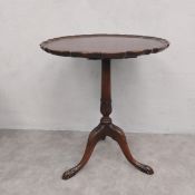 An early 20th century mahogany Georgian style wine table with tilt-top action on tripod base. H.72