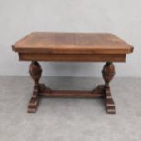 A mid-century oak draw leaf extending dining table in the Jacobean style. 80 x 107 x 84cm ext 168cm