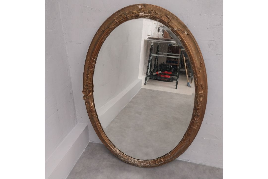 A late 19th century oval wall mirror in giltwood and foliate gesso frame. 92 x 65cm - Image 1 of 3